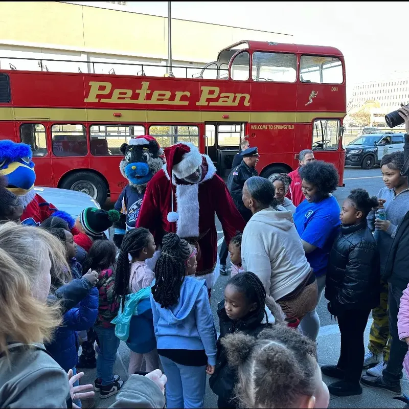 Coach Claus, accompanied by special guests and local mascots